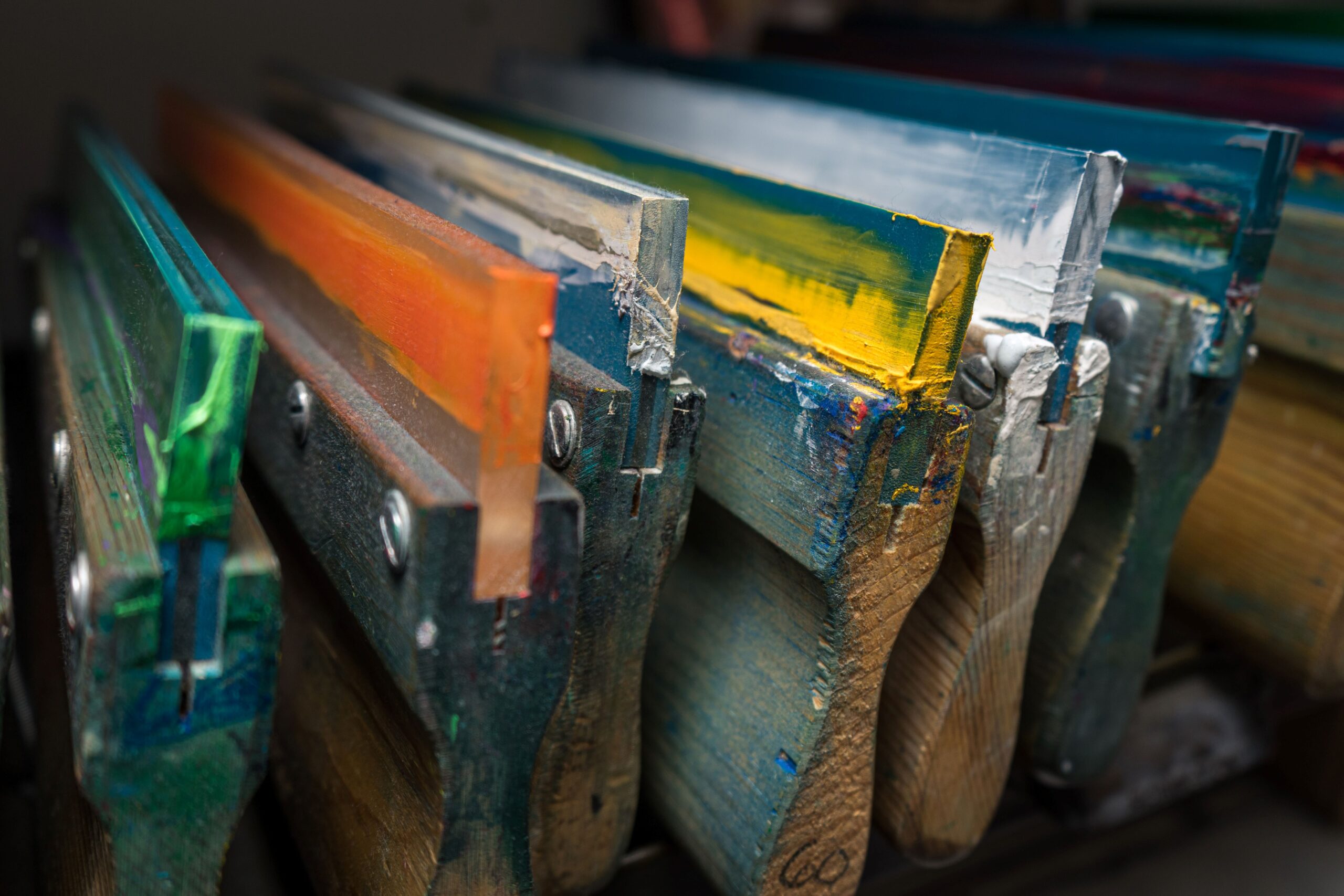 Squeegees with ink on them stored in a screen print shop. 