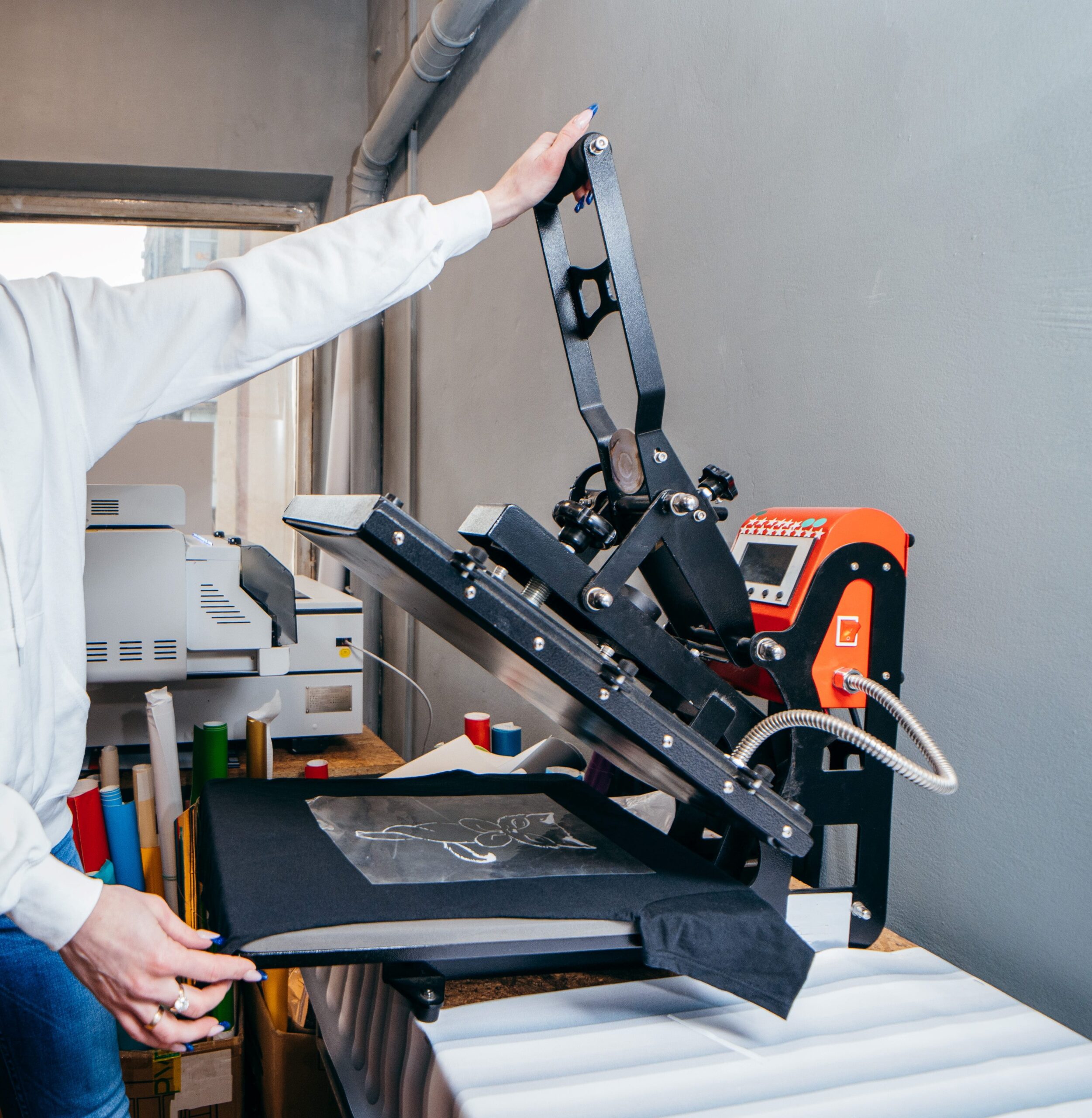 Direct to Film transfer being applied to a shirt on a heat press machine.